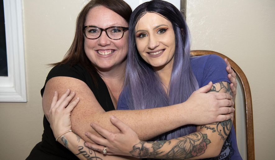 In this Dec. 9, 2019 photo, Angela Pitcher, left, and Danielle Smith pose in Battle Creek, Mich. Angela's non-profit Home Pride Cleaning cleaned Dani's home for free while she recovered from chemotherapy. Pitcher learned of Smith's plight through a fundraising effort on Facebook. The owner of Home Pride Cleaning in Battle Creek, she determined that Smith would be the first recipient of a free cleaning service, provided through her new nonprofit, Giving Pride Back. (Alyssa Keown/Battle Creek Enquirer via AP)