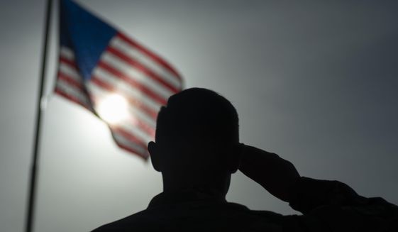 In this photo taken Aug. 26, 2019 and released by the U.S. Air Force, U.S. Air Force Staff Sgt. Devin Boyer, 435th Air Expeditionary Wing photojournalist, salutes the flag during a ceremony signifying the change from tactical to enduring operations at Camp Simba, Manda Bay, Kenya. The al-Shabab extremist group said Sunday, Jan. 5, 2020 that it has attacked the Camp Simba military base used by U.S. and Kenyan troops in coastal Kenya, while Kenya&#39;s military says the attempted pre-dawn breach was repulsed and at least four attackers were killed. (Staff Sgt. Lexie West/U.S. Air Force via AP)