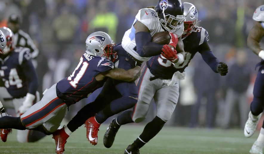 New England Patriots defensive back Jonathan Jones, left, tries to bring down Tennessee Titans running back Derrick Henry in the first half of an NFL wild-card playoff football game, Saturday, Jan. 4, 2020, in Foxborough, Mass. (AP Photo/Charles Krupa)