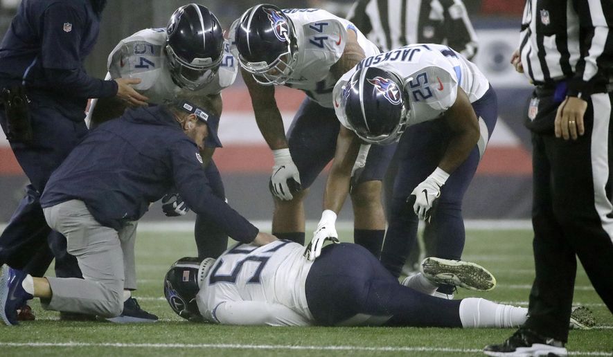 Tennessee Titans linebacker Jayon Brown receives attention on the field after an injury in the first half of an NFL wild-card playoff football game against the New England Patriots, Saturday, Jan. 4, 2020, in Foxborough, Mass. (AP Photo/Elise Amendola)