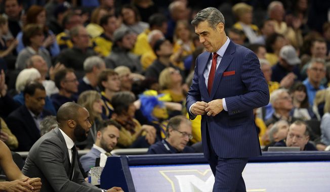 Villanova head coach Jay Wright buttons his suit jacket during the second half of an NCAA college basketball game against Marquette, Saturday, Jan. 4, 2020, in Milwaukee. (AP Photo/Aaron Gash)