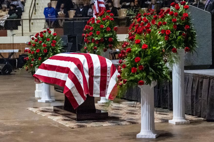 The casket sits, under a U.S. Flag, flanked by rose bushes, during the memorial service for slain Lowndes County Sheriff &amp;quot;Big John&amp;quot; Williams, Monday, Dec. 2, 2019, in Montgomery, Ala. (AP Photo/Vasha Hunt)