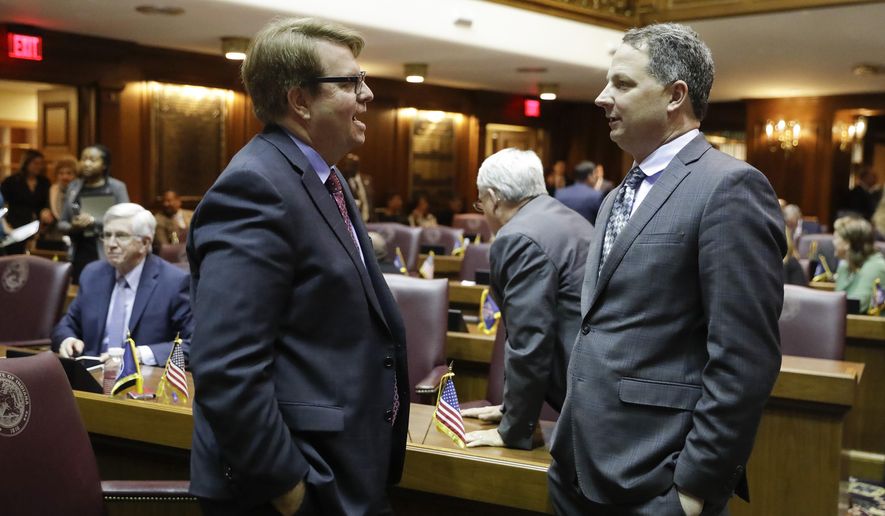 House Minority Leader Phil GiaQuinta, D-Fort Wayne, speaks with Rep. Todd Huston, R-Fishers, during the opening day of the session at the Statehouse, Monday, Jan. 6, 2020, in Indianapolis. (AP Photo/Darron Cummings)