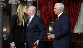 Sen. Kelly Loeffler, R-Ga., left, gets a kiss from her husband Jeffrey Sprecher, after Vice President Mike Pence presided in a re-enactment of Loeffler&#39;s swearing-in Monday Jan. 6, 2020, in the Old Senate Chamber on Capitol Hill in Washington. (AP Photo/Jacquelyn Martin)