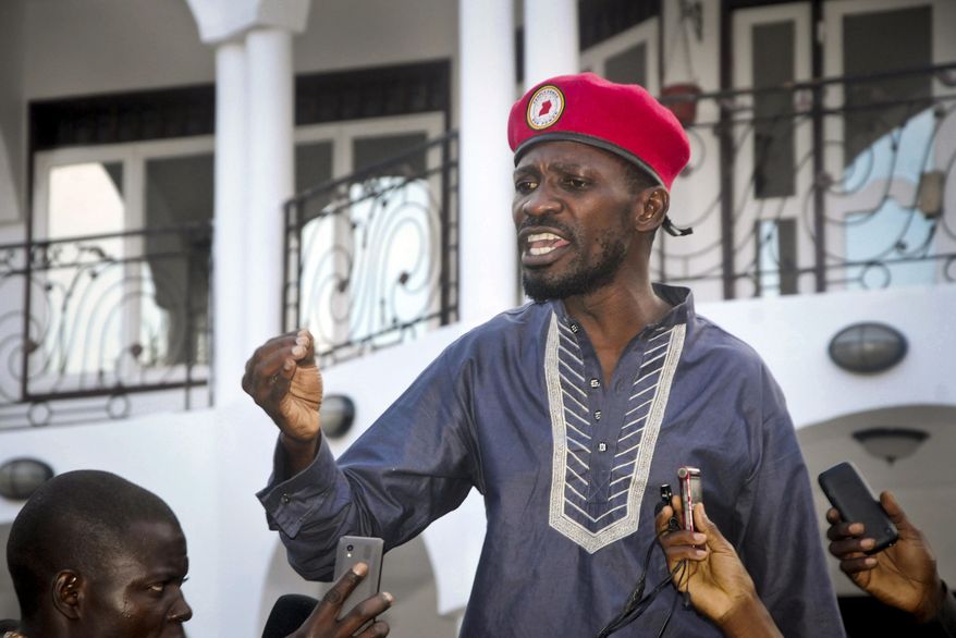 FILE - In this Thursday, May 2, 2019 file photo, Ugandan pop star singer and political opposition activist Bobi Wine, whose real name is Kyagulanyi Ssentamu, greets his followers as he arrives home after being released from prison on bail in Kampala, Uganda. Ugandan police on Monday, Jan. 6, 2020, detained Wine, who was prevented from holding his first public meeting with supporters as a presidential aspirant. (AP Photo/Ronald Kabuubi, File)