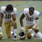 Notre Dame wide receiver Joe Wilkins (18) and cornerback Temitope Agoro (26) pray in the end zone before the Camping World Bowl NCAA college football game against Iowa State Saturday, Dec. 28, 2019, in Orlando, Fla. (AP Photo/Phelan M. Ebenhack)