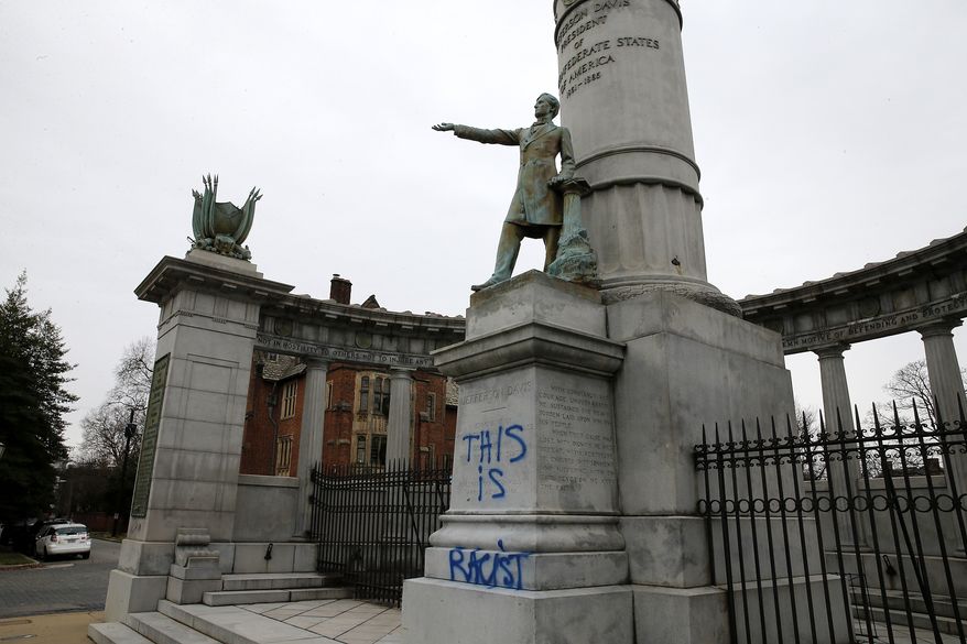 Spray paint defaces the Jefferson Davis Monument along Monument Ave. in Richmond, Va.. Tuesday, Jan. 7, 2020. Davis was the president of the Confederacy, which had its capital in Richmond. A Stonewall Jackson monument in the city was also vandalized, spray-painted with the phrase “God is Gay.” (Mark Gormus/Richmond Times-Dispatch via AP)