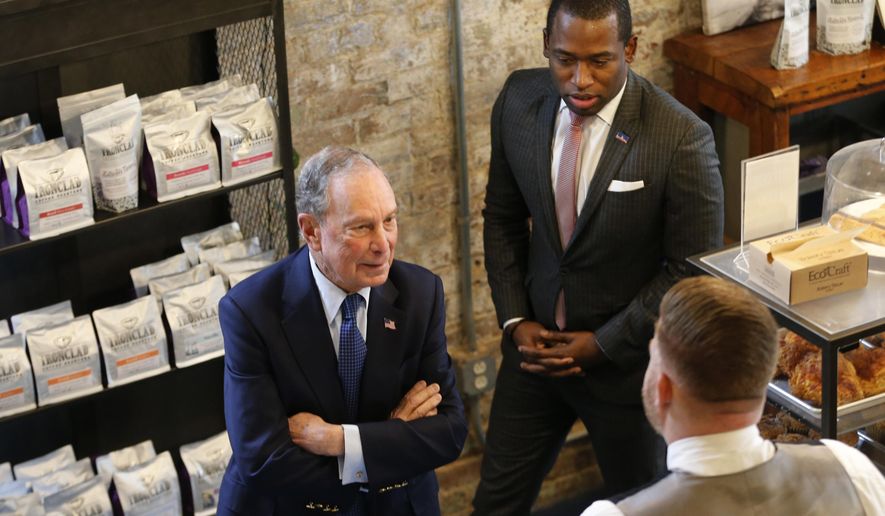 Democratic presidential candidate, former New York Mayor Michael Bloomberg, places an order with Richmond mayor Levar Stoney at a coffee shop in Richmond, Va., Tuesday, Jan. 7, 2020. (AP Photo/Steve Helber)