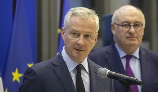 French Finance Minister Bruno Le Maire, left, and European Trade Commissioner Phil Hogan attend a media conference after their meeting in Paris, Tuesday, Jan. 7, 2020. The talks are focused on U.S. tariffs on French wine and other goods. (AP Photo/Michel Euler)