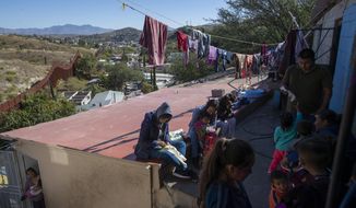 FILE - In this Oct. 31, 2019 photo, migrants rest at &amp;quot;La Roca,&amp;quot; or The Rock shelter in Nogales, Sonora state, Mexico, near the border fence, top left, that separates Mexico from the U.S. As the U.S. moved aggressively over the past year to sharply reduce the number of asylum seekers arriving at its southwest border, Mexicans were spared, but now Mexico is expressing its displeasure at U.S. plans to send Mexican asylum seekers some 2,000 miles south to Guatemala. (AP Photo/Moises Castillo, File)