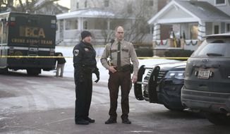 Law enforcement officers work at the scene of a shooting in Waseca, Minn., on Tuesday, Jan. 7, 2019. A Waseca police officer and a suspect were shot Monday night after reports of a disturbance in a residential neighborhood, according to the Minnesota Bureau of Criminal Apprehension. (David Joles/Star Tribune via AP)