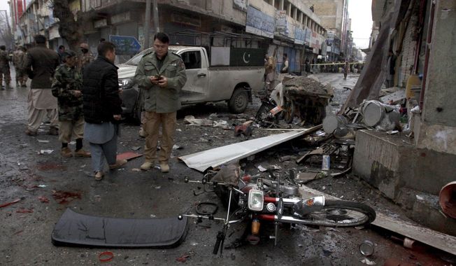 Pakistani police officers examine the site of a bomb explosion in Quetta, Pakistan, Tuesday, Jan. 7, 2020. A powerful roadside bomb exploded near a vehicle carrying Pakistani security forces in the country&#x27;s southwest, killing soldiers and wounded others, a police official said. (AP Photo/Arshad Butt)
