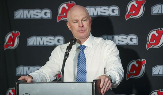 FILE - In this Monday, Oct. 14, 2019, file photo, New Jersey Devils head coach John Hynes talks to reporters after an NHL hockey game against the Florida Panthers in Newark, N.J. The Nashville Predators have hired former New Jersey Devils coach John Hynes as the third coach in franchise history hours after firing Peter Laviolette.  The Predators announced the hiring Tuesday morning, Jan. 7, 2020, before a morning skate. (AP Photo/Mary Altaffer, File)