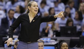 FILE - In this April 4, 2016, file photo, Tufts head coach Carla Berube directs her team as they play Thomas More during the first half of the championship game at the women&#x27;s NCAA Division III basketball tournament in Indianapolis. Princeton coach Berube knew she inherited a really good team when she took over the Tigers this year after Courtney Banghart left to coach North Carolina.(AP Photo/Michael Conroy, File)