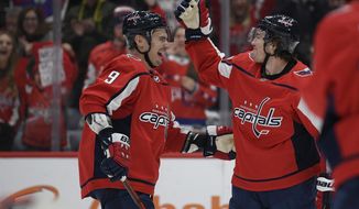 Washington Capitals right wing T.J. Oshie, right, celebrates his goal with defenseman Dmitry Orlov (9), of Russia, during the second period of an NHL hockey game against the Ottawa Senators, Tuesday, Jan. 7, 2020, in Washington. (AP Photo/Nick Wass) ** FILE **