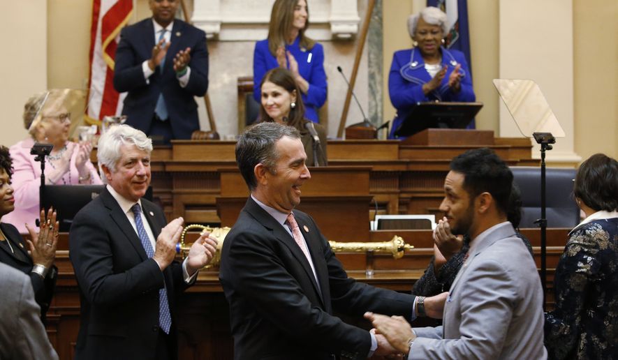 Virginia Gov. Ralph Northam, center, shakes the hand of Del. Suhas Subramanyam, D-Loudoun, while leaving the chamber after delivering his State of the Commonwealth address before a joint session of the Assembly at the state Capitol in Richmond, Va., Wednesday, Jan. 8, 2020. (AP Photo/Steve Helber)