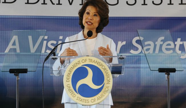 In this Sept. 12, 2017 file photo,  U.S. Transportation Secretary Elaine Chao announces new voluntary safety guidelines for self-driving cars during a visit to an autonomous vehicle testing facility at the University of Michigan, in Ann Arbor, Mich.  The Trump administration announced its most recent round of guidelines for autonomous vehicle makers, continuing to rely on the industry to police itself despite calls for specific regulations.  Chao announced the proposed guidelines in a speech Wednesday, Jan. 8, 2020 at the CES gadget show in Las Vegas, saying in prepared remarks that “AV 4.0” will ensure U.S. leadership in developing new technologies.(Hunter Dyke/The Ann Arbor News via AP, File)  **FILE**