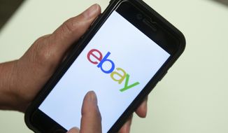 FILE - In this July 11, 2019, file photo, an Ebay app is shown on a mobile phone in Miami. Britain&#39;s competition watchdog said Wednesday, Jan. 8, 2020 that Facebook and eBay pledged to crack down on the trade in fake reviews at its request, removing hundreds of accounts, pages and groups involved in the illicit business. (AP Photo/Wilfredo Lee, File)