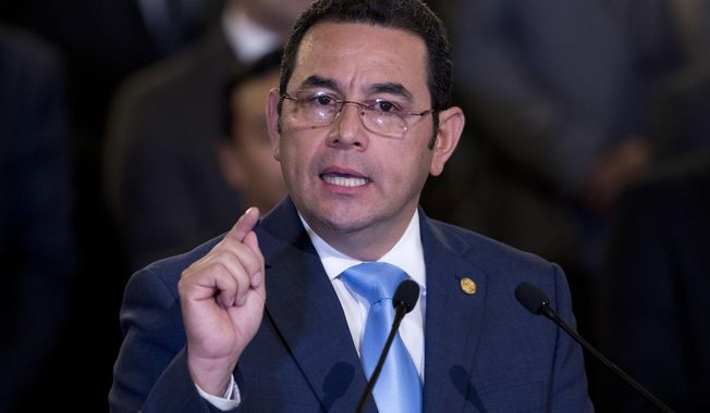 File - In this Jan. 7, 2019 file photo, Guatemala&#x27;s President Jimmy Morales gives a statement, at the National Palace in Guatemala City. Outgoing President Morales says his government has not agreed to receive Mexicans who had sought asylum in the United States. Morales, whose presidency ends next week, said that he had told U.S. officials that would have to be negotiated with his successor. (AP Photo/Moises Castillo, File)
