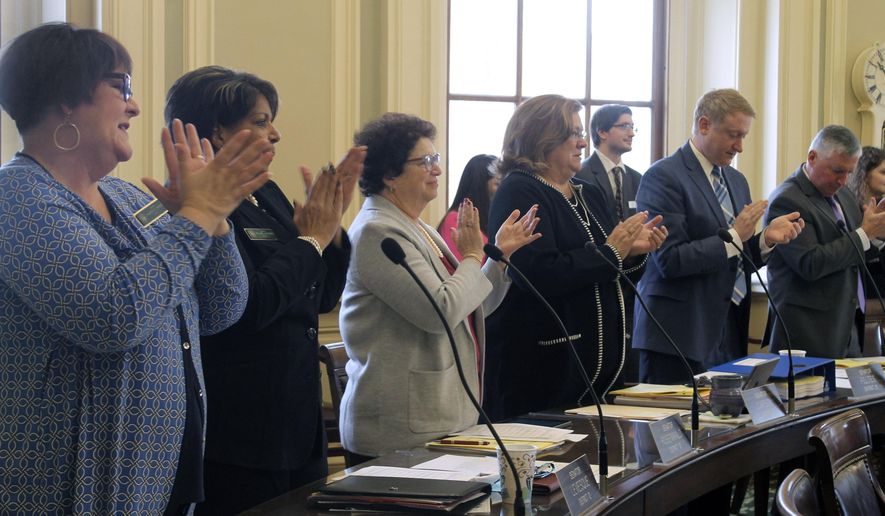 State Senators applaud in tribute to long-serving New Hampshire Statehouse staffers Wednesday, Jan. 8, 2020, at the Statehouse in Concord, N.H. The House and Senate returned to for the first day of their new legislative session, spent the time dealing with more than 150 bills retained in committees from last year. (AP Photo/Holly Ramer)