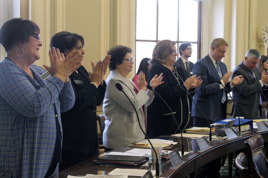 State Senators applaud in tribute to long-serving New Hampshire Statehouse staffers Wednesday, Jan. 8, 2020, at the Statehouse in Concord, N.H. The House and Senate returned to for the first day of their new legislative session, spent the time dealing with more than 150 bills retained in committees from last year. (AP Photo/Holly Ramer)