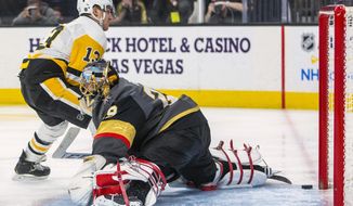 Pittsburgh Penguins&#39; Brandon Tanev (13) scores on Vegas Golden Knights goaltender Marc-Andre Fleury (29) during the third period of an NHL hockey game Tuesday, Jan. 7, 2020, in Las Vegas. (AP Photo/L.E. Baskow)