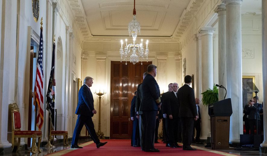 President Donald Trump, left, arrives to address the nation on the ballistic missile strike that Iran launched against Iraqi air bases housing U.S. troops, at the White House, Wednesday, Jan. 8, 2020, in Washington. (AP Photo/Alex Brandon)