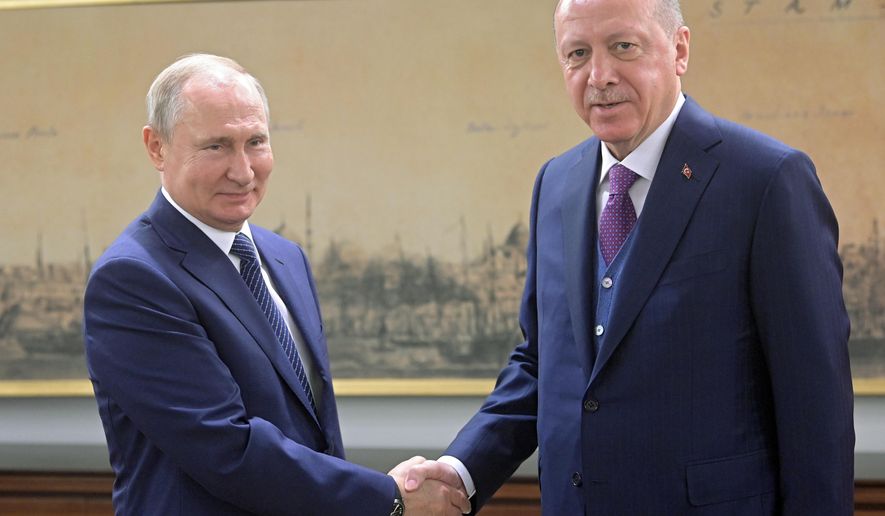 Turkish President Recep Tayyip Erdogan, right, and Russian President Vladimir Putin pose for photos before their talks in Istanbul, Wednesday, Jan. 8, 2020. Putin and Erdogan are meeting in Istanbul to inaugurate the dual natural gas line, TurkStream, connecting their countries that will open up a new export path for Russian gas into Turkey and Europe. Erdogan and Putin are also expected to discuss the middle east. (Sergei Guneyev, Sputnik, Kremlin Pool Photo via AP)