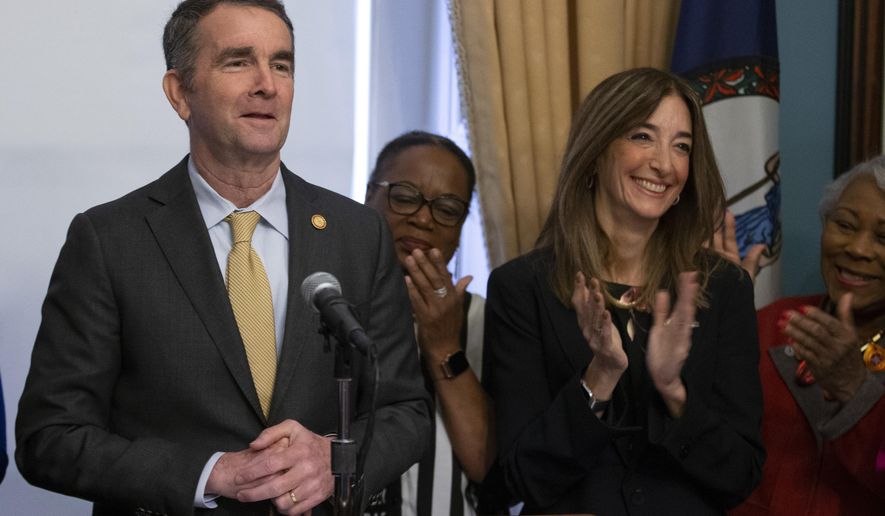Virginia Gov. Ralph Northam, left, and Virginia House of Delegates speaker-designate, Eileen Filler-Corn, front right, are surrounded by Democratic Legislators as he outlines his legislative agenda at the Capitol in Richmond, Va., Tuesday, Jan. 7, 2020. (AP Photo/Steve Helber)
