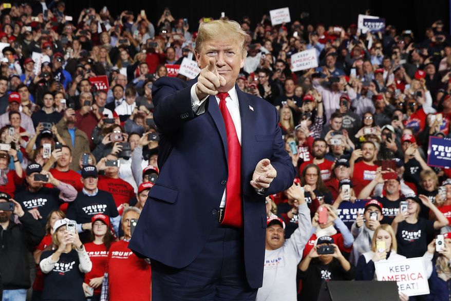 President Donald Trump points as he arrives to speak at a campaign rally, Thursday, Jan. 9, 2020, in Toledo, Ohio. (AP Photo/ Jacquelyn Martin)