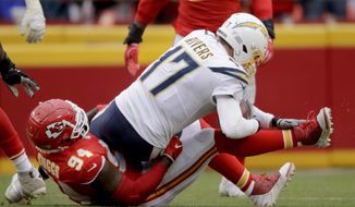Kansas City Chiefs defensive end Terrell Suggs (94) sacks Los Angeles Chargers quarterback Philip Rivers (17) during the second half of an NFL football game in Kansas City, Mo., Sunday, Dec. 29, 2019. (AP Photo/Charlie Riedel)