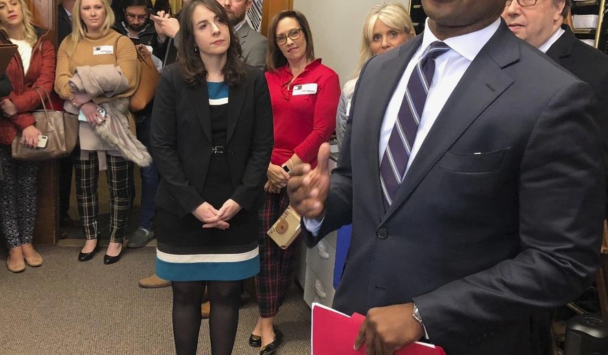 Kentucky Attorney General Daniel Cameron delivers paperwork to the Secretary of State's office at the Kentucky Capitol, Thursday, Jan. 9, 2020, in Frankfort, Ky., to put President Donald Trump’s name on the state’s ballot this year. Cameron was joined by other prominent Republicans including state Treasurer Allison Ball and state GOP Chairman Mac Brown. Trump easily carried Kentucky in 2016 and is an overwhelming favorite to do so again this year. (AP Photo/Bruce Schreiner)