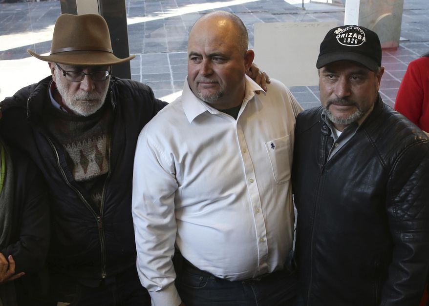 Mexican writer and activist Javier Sicilia, left, Julian, center, and Adrian LeBaron, who lost relatives and friends in a Nov. 4, 2019 ambush in northern Mexico, pose for photos during a press conference in Mexico City, Thursday, Jan. 9, 2020. Sicilia and other activists are calling to march against violence on Jan. 23, from Cuernavaca, Morelos state, to the National Palace in the Mexico’s capital. (AP Photo/Marco Ugarte)