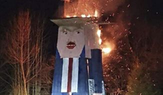 In this photo provided by the municipality of Moravce, wooden sculpture resembling U.S. president Trump is on fire, in Moravce, Slovenia, Thursday, Jan. 9, 2020. The wooden nearly eight-meter high (26 feet) statue mocking U.S. President Donald Trump that was constructed last year, has been destroyed by fire in the homeland of his wife Melania Trump. (Municipality of Moravce via AP)