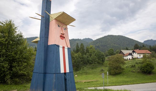 FILE - In this file photo dated Friday, Aug. 30, 2019, a wooden statue resembling Donald Trump near Kamnik, Slovenia.  The wooden statue nearly eight-meter high (26 feet) of U.S. President Donald Trump that was constructed in 2019, has been destroyed by fire Thursday Jan. 9, 2020, in the homeland of his wife Melania Trump. (AP Photo/Darko Bandic, FILE)