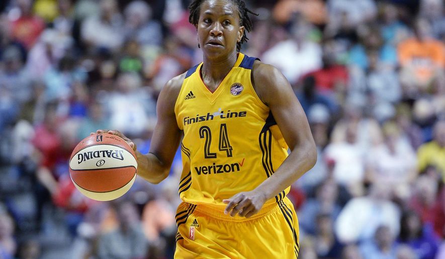 FILE - In this June 5, 2016, file photo, Indiana Fever's Tamika Catchings brings the ball up during the first half of a WNBA basketball game against the Connecticut Sun in Uncasville, Conn. Catchings is among 12 finalists announced Thursday, Jan. 9, for the Women's Basketball Hall of Fame Class of 2020.p (AP Photo/Jessica Hill, File)