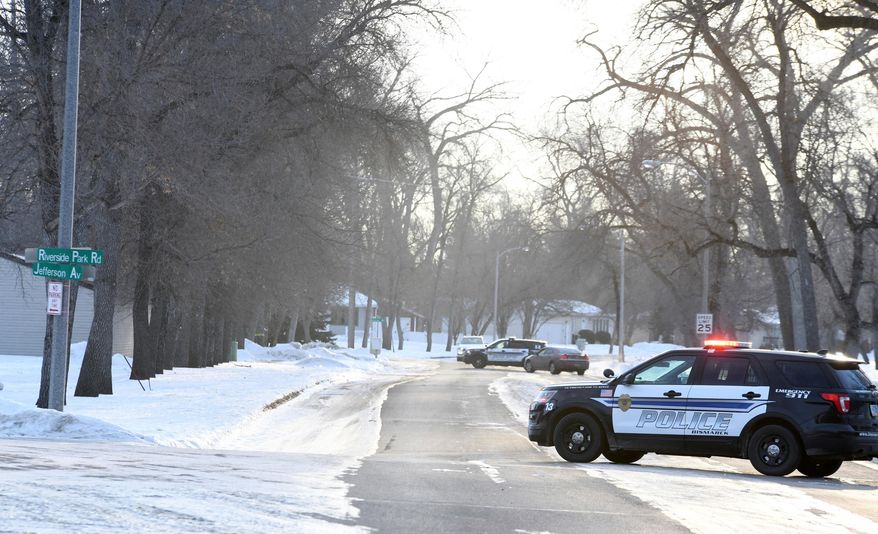 Police control access to the 100 block of Riverside Park Road in Bismarck, N.D., on Friday, Jan. 10, 2020 after a member of the West Dakota SWAT shot and killed a 30-year-old man during a stand-off late Thursday night. (Mike McCleary/The Bismarck Tribune via AP)