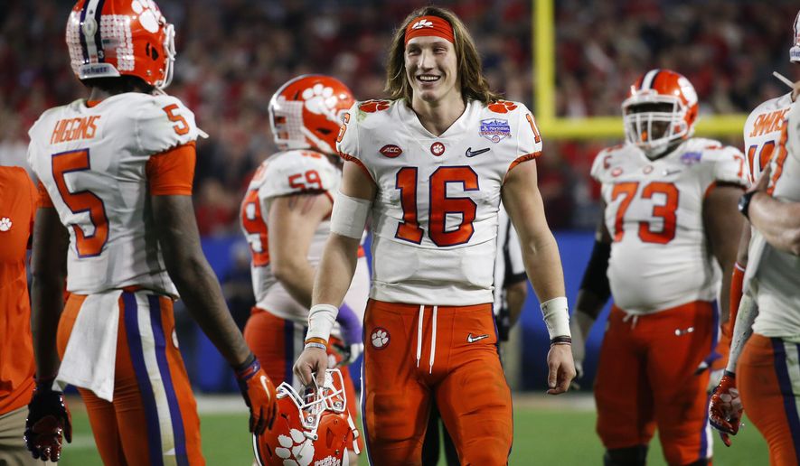 Clemson quarterback Trevor Lawrence (16) smiles after Clemson defeated Ohio State 29-23 in the Fiesta Bowl NCAA college football playoff semifinal Saturday, Dec. 28, 2019, in Glendale, Ariz. (AP Photo/Ross D. Franklin)
