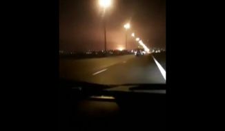 This image taken from a video on Wednesday Jan. 8, 2020 shows a light in the sky which appears to show the Ukrainian jetliner plane on fire and crashing into ground. Western leaders have said the plane appeared to have been unintentionally hit by a surface-to-air missile near Tehran, just hours after Iran launched a series of ballistic missiles at two US bases in Iraq to avenge the killing of its top general in an American airstrike last week. Iran on Friday Jan. 10, 2020, denied the allegations. (UGC via AP)