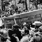 FILE - In this July 7, 1988 file photo, Iranian mourners carry one of 72 caskets to the Cemetery of Martyrs after attending a &amp;quot;Death to America&amp;quot; rally outside the Majlis, or Iranian parliament, in Tehran, Iran. The Western allegation that Iran shot down a Ukrainian jetliner and killed 176 people offers a grim echo for the Islamic Republic, which found itself the victim of an accidental shootdown by American forces over 30 years ago. (AP Photo/Greg English, File)