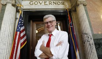 Gov. Phil Bryant stands outside his Capitol office in Jackson, Miss., Jan. 8, 2020. With much of his adult life devoted to public service, Bryant leaves a strong legacy. Gov.-elect Tate Reeves will be sworn into office at noon Tuesday, Jan. 14. (AP Photo/Rogelio V. Solis)
