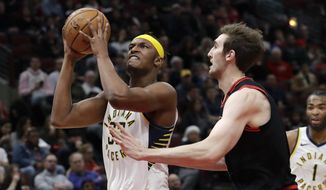Indiana Pacers&#39; Myles Turner, left, drives to the basket against Chicago Bulls&#39; Luke Kornet during the first half of an NBA basketball game in Chicago, Friday, Jan. 10, 2020. (AP Photo/Nam Y. Huh)