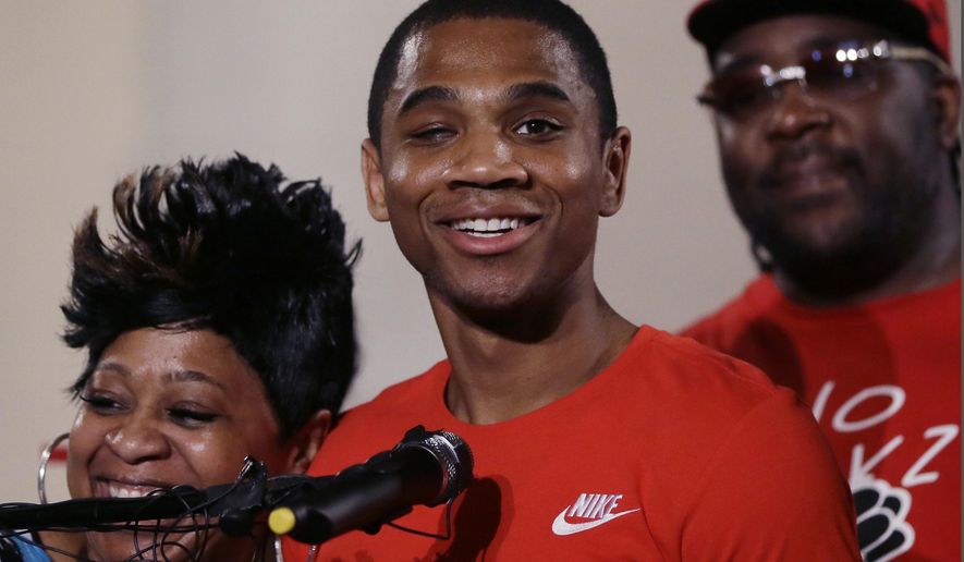 FILE - In this June 9, 2016, file photo, Davontae Sanford stands with his mother, Taminko Sanford, and addresses the media during a news conference in Detroit, a day after being released from prison. Michigan State Police said blood on the shoe of Davontae Sanford who was convicted but subsequently cleared of four murders reveals DNA from one of the victims. The disclosure was made in a recent filing in Detroit federal court where Davontae Sanford is suing Detroit police over the 2007 investigation. (AP Photo/Carlos Osorio, File)