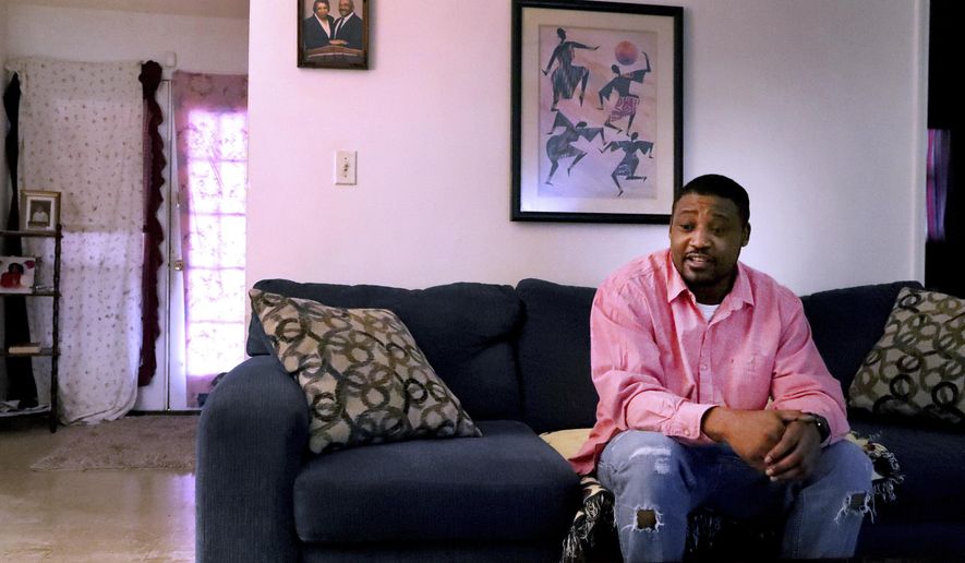 Marques Martin talks in his home in Murfreesboro, Tenn., on Thursday, Dec. 12, 2019, about how he continued to get arrested from 2001-2018 for not paying probation fines. (Helen Comer/The Daily News Journal via AP)