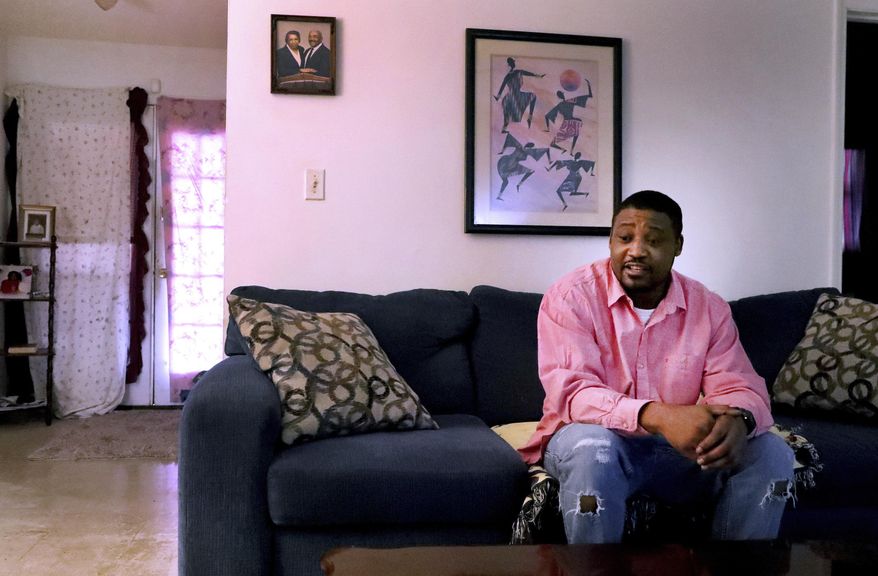 Marques Martin talks in his home in Murfreesboro, Tenn., on Thursday, Dec. 12, 2019, about how he continued to get arrested from 2001-2018 for not paying probation fines. (Helen Comer/The Daily News Journal via AP)