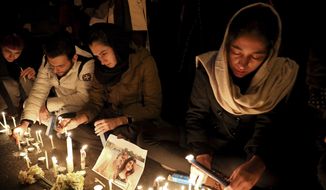 People gather for a candlelight vigil to remember the victims of the Ukraine plane crash, at the gate of Amri Kabir University that some of the victims of the crash were former students of, in Tehran, Iran, Saturday, Jan. 11, 2020. Iran on Saturday, Jan. 11, acknowledged that its armed forces &amp;quot;unintentionally&amp;quot; shot down the Ukrainian jetliner that crashed earlier this week, killing all 176 aboard, after the government had repeatedly denied Western accusations that it was responsible. (AP Photo/Ebrahim Noroozi)