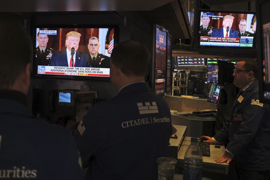 FILE - In this Jan. 8, 2020, file photo traders pause to watch a televised speech by President Donald Trump as they work the floor of the New York Stock Exchange in New York. A potentially tumultuous presidential election campaign promises to add some extra drama to financial markets this year, although if history is any guide investors can cast aside some worries. (AP Photo/Seth Wenig, File)