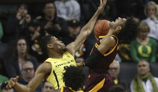 Oregon&#39;s Francis Okoro, left, fouls Arizona State&#39;s Remy Martin during the first half of an NCAA college basketball game in Eugene, Ore., Saturday, Jan. 11, 2020. (AP Photo/Chris Pietsch)