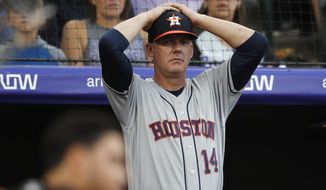 FILE - In this July 2, 2019, file photo, Houston Astros manager AJ Hinch reacts during a baseball game against the Colorado Rockies, in Denver. Houston  manager AJ Hinch and general manager Jeff Luhnow were suspended for the entire season Monday, Jan. 13, 2020,  and the team was fined $5 million for sign-stealing by the team in 2017 and 2018 season. Commissioner Rob Manfred announced the discipline and strongly hinted that current Boston manager Alex Cora — the Astros bench coach in 2017 — will face punishment later. Manfred said Cora developed the sign-stealing system used by the Astros. (AP Photo/David Zalubowski, File)
