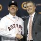 FILE - In this Sept. 29, 2014, file photo, Houston Astros general manager Jeff Luhnow, right, and A.J. Hinch pose after Hinch is introduced as the new manager of the baseball club in Houston. Hinch and Luhnow were fired Monday, Jan. 13, 2020, after being suspended for their roles in the team&#x27;s extensive sign-stealing scheme from 2017.  (AP Photo/Pat Sullivan, File)